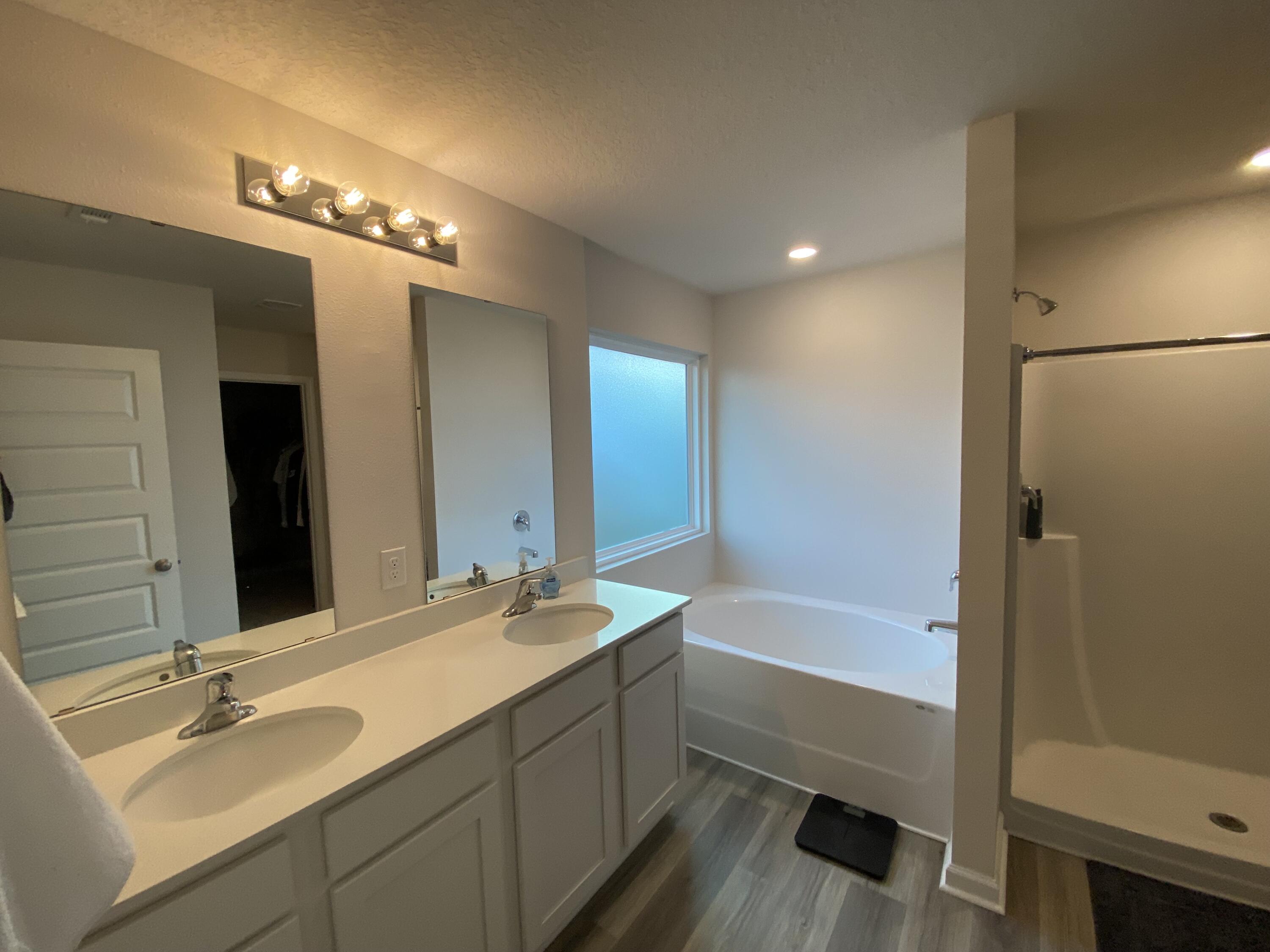 337 Flounder Street Crestview, FL 32539 - Photo 32 of 46 a bathroom with a tub a sink and a large mirror