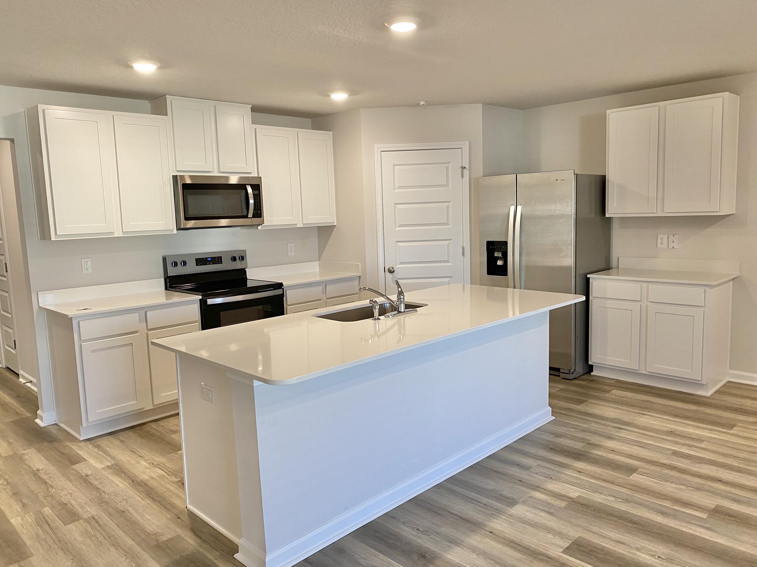 337 Flounder Street Crestview, FL 32539 - Photo 32 of 53 a large kitchen with stainless steel appliances a sink a stove a refrigerator and cabinets