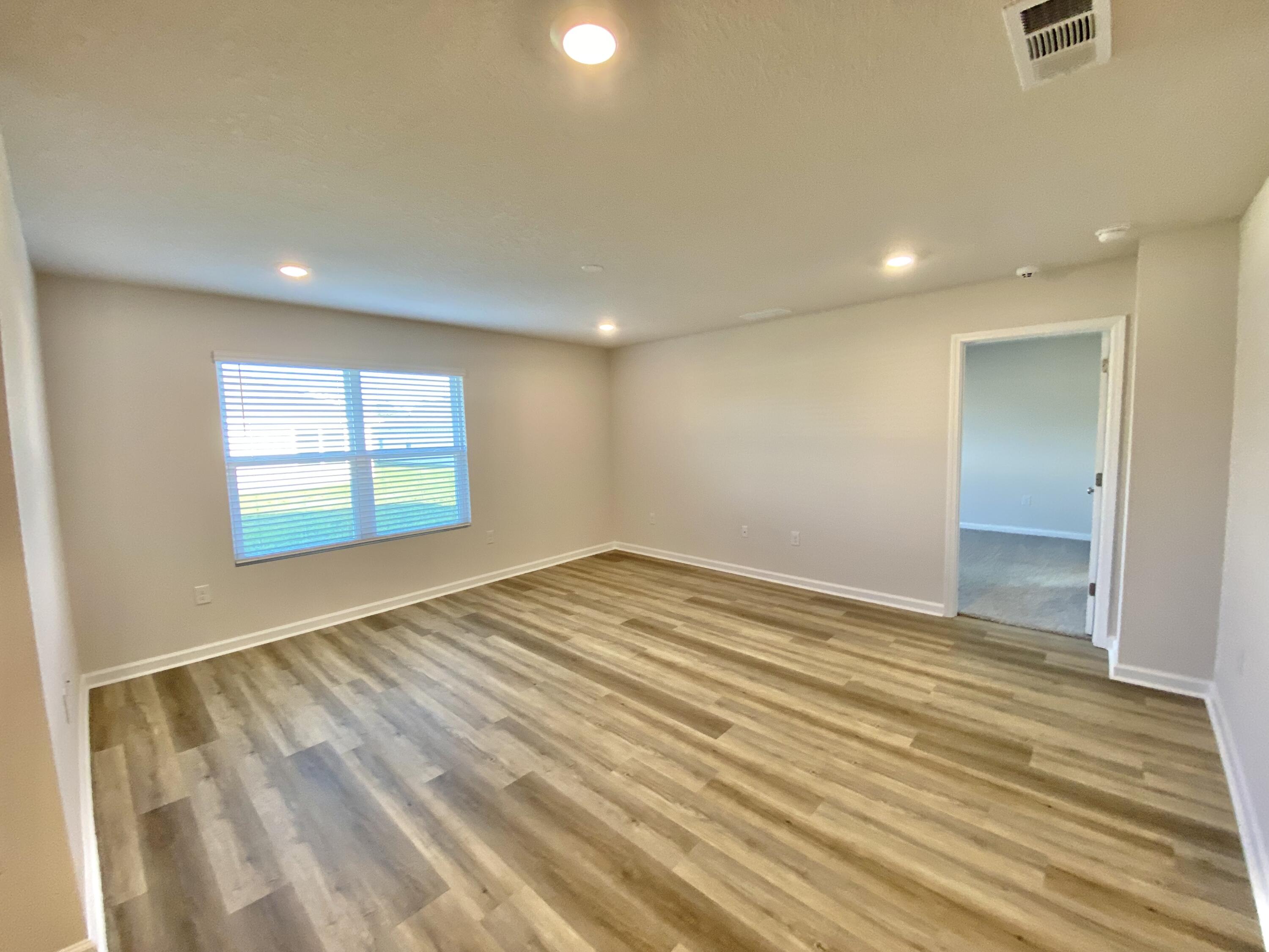 337 Flounder Street Crestview, FL 32539 - Photo 33 of 53 an empty room with wooden floor and windows