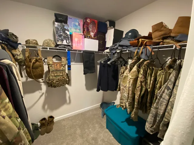 a view of walk in closet with clothes
