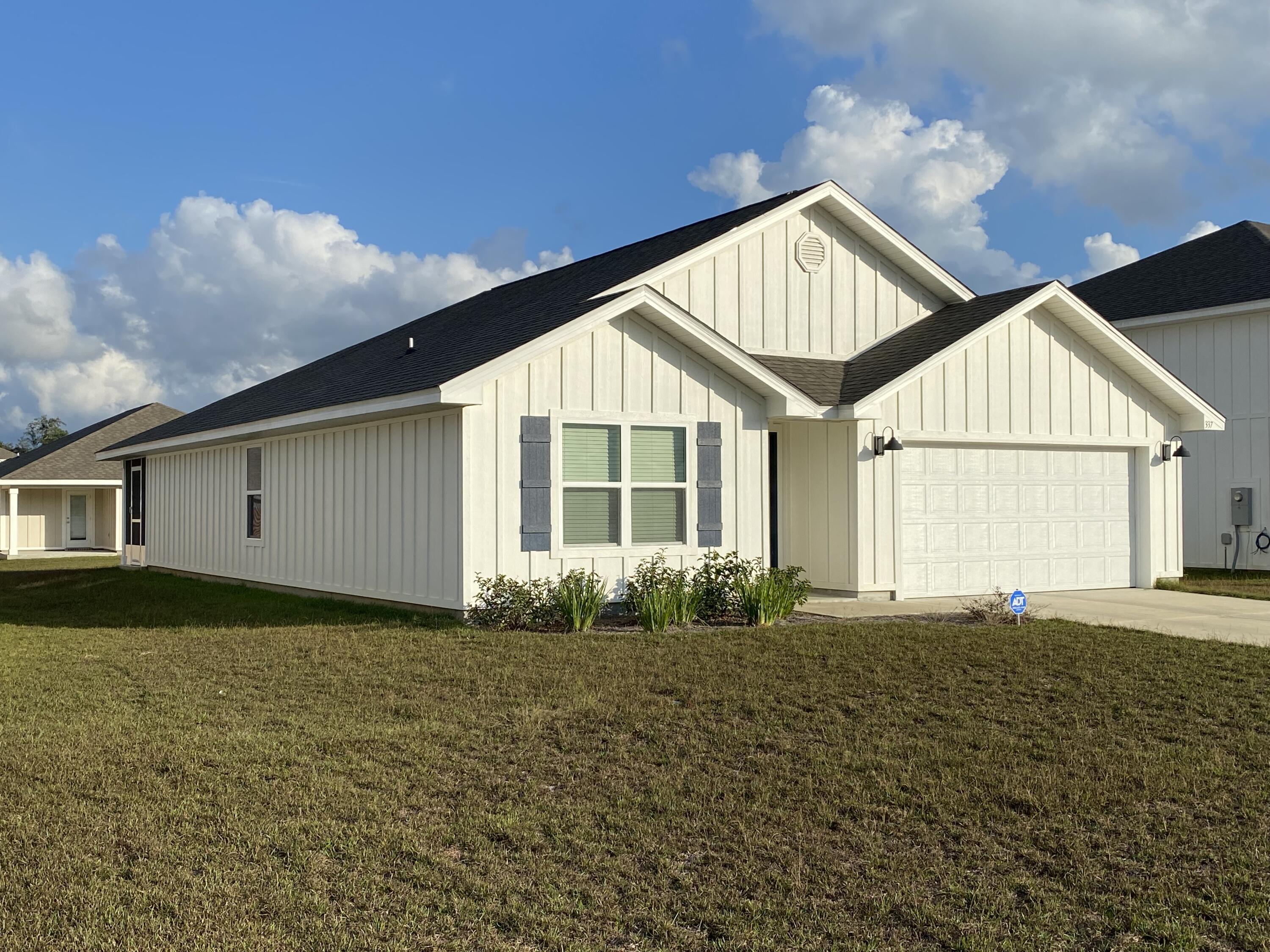 337 Flounder Street Crestview, FL 32539 - Photo 10 of 53 a front view of a house with garden