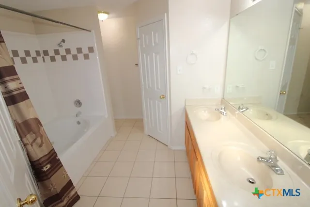 a bathroom with a tub sink and mirror