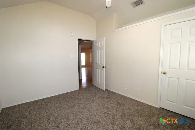 an empty room with closet area