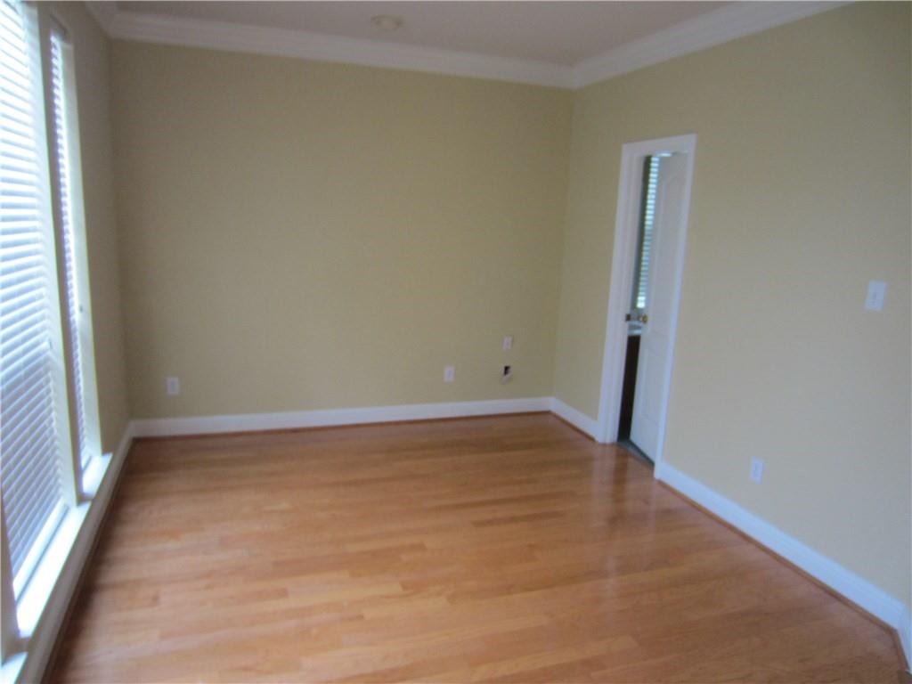 1800 Chester Drive Plano, TX 75025 - Photo 11 of 14 an empty room with wooden floor and windows