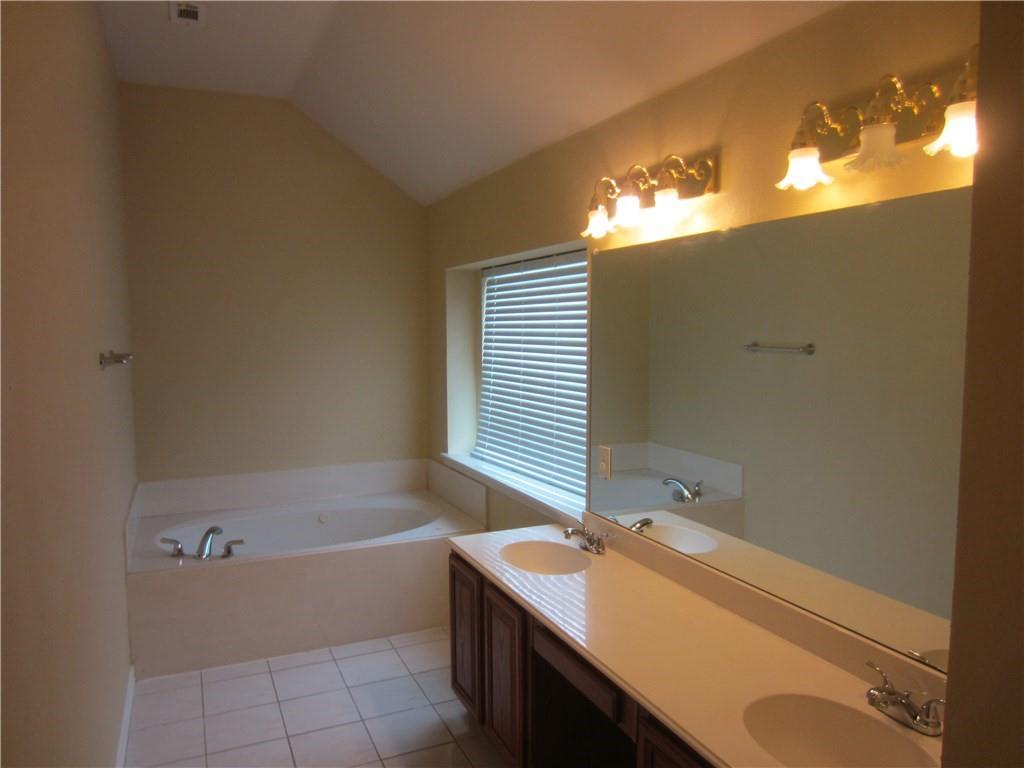 1800 Chester Drive Plano, TX 75025 - Photo 2 of 14 a bathroom with a sink and a bathtub