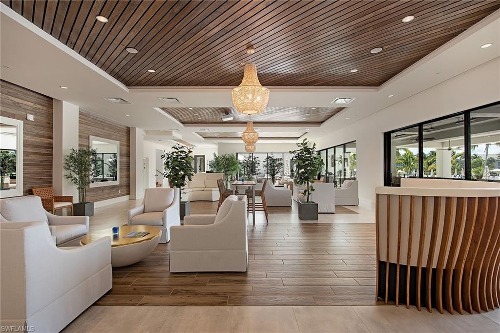 325 Dunes Boulevard, Unit 607 Naples, FL 34110 - Photo 15 of 27 a living room with furniture and a large window
