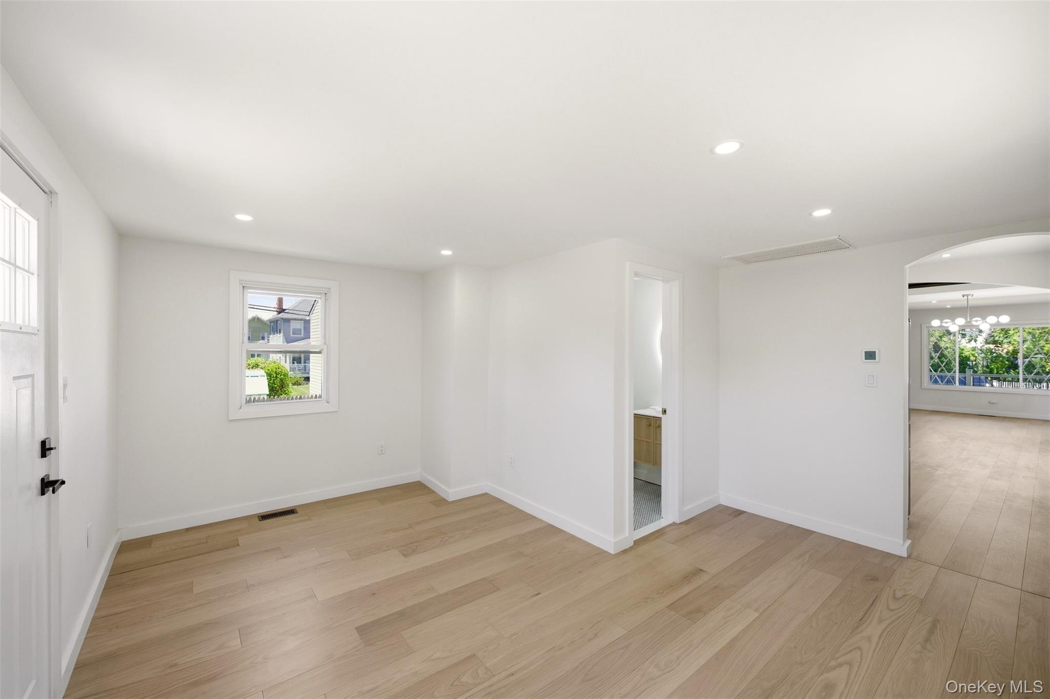 135 Whaley Street Freeport, NY 11520 - Photo 24 of 38 an empty room with wooden floor and window