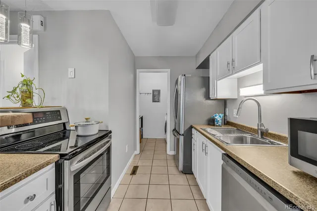 a kitchen with a sink cabinets and appliances