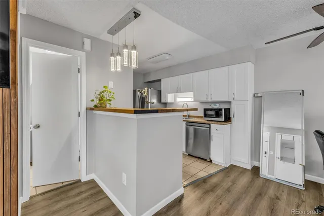 a kitchen with granite countertop a sink stove and cabinets