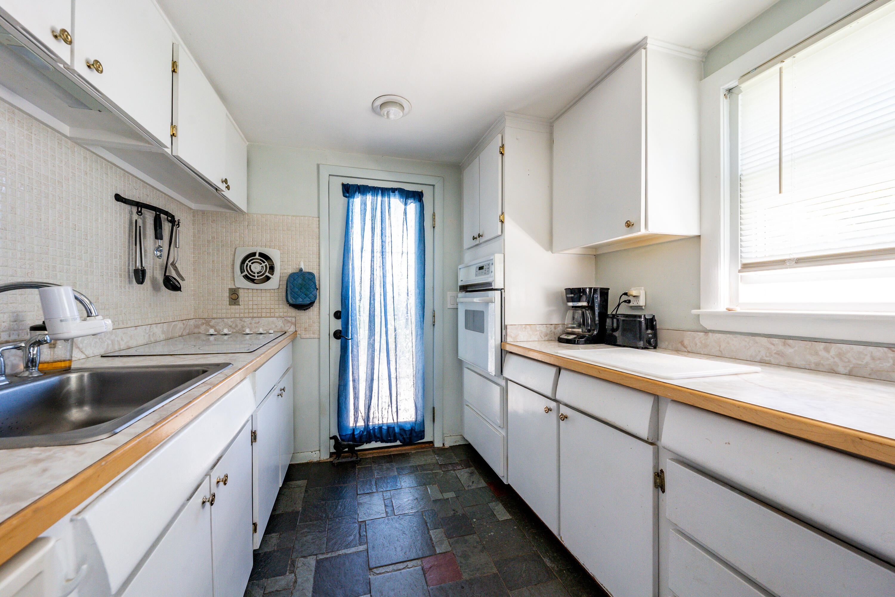 40 Seabrook Road Hyannis, MA 02601 - Photo 11 of 45 a kitchen with a sink dishwasher and white cabinets