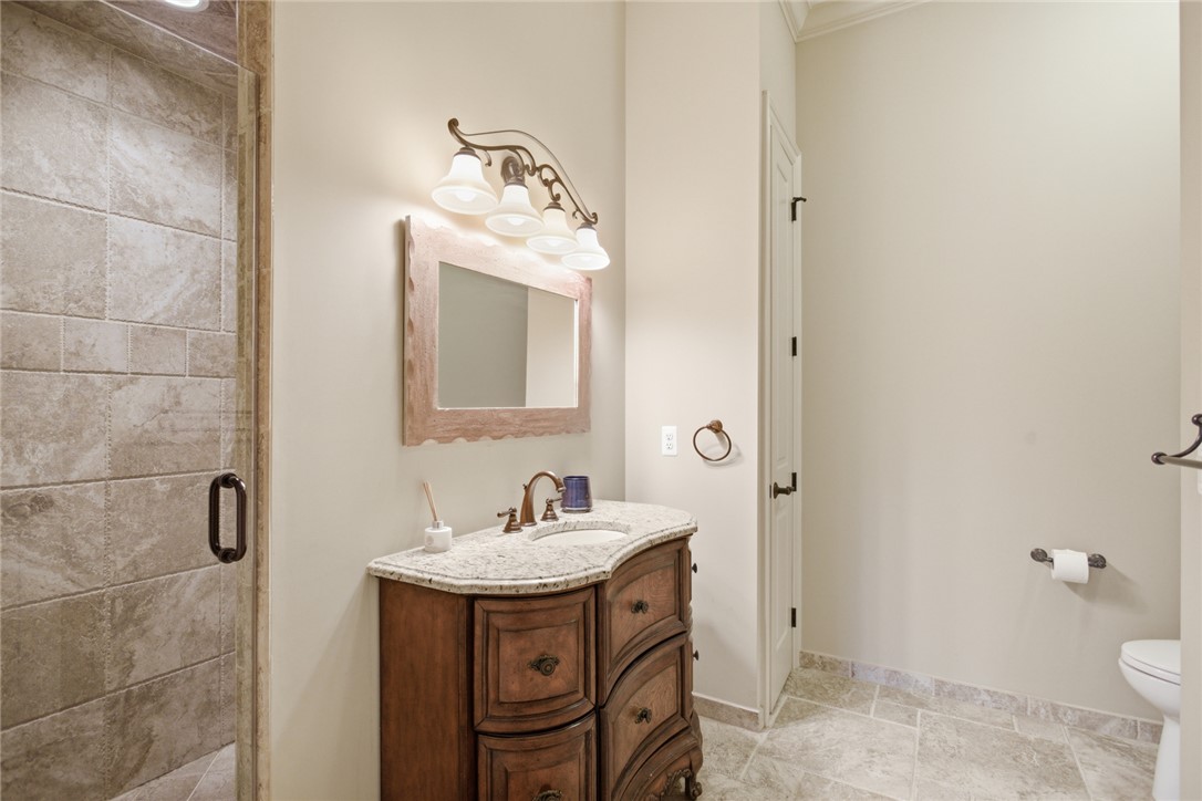 130 River Ridge Road Sunset, SC 29685 - Photo 30 of 47 This primary bathroom features a shower with glass enclosure and an elegant vanity with granite countertop.