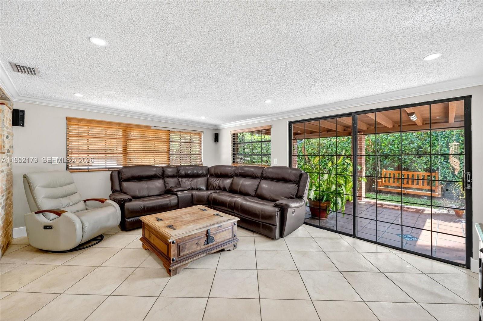 1300 West 77th Street Hialeah, FL 33014 - Photo 11 of 41 a living room with furniture and a floor to ceiling window