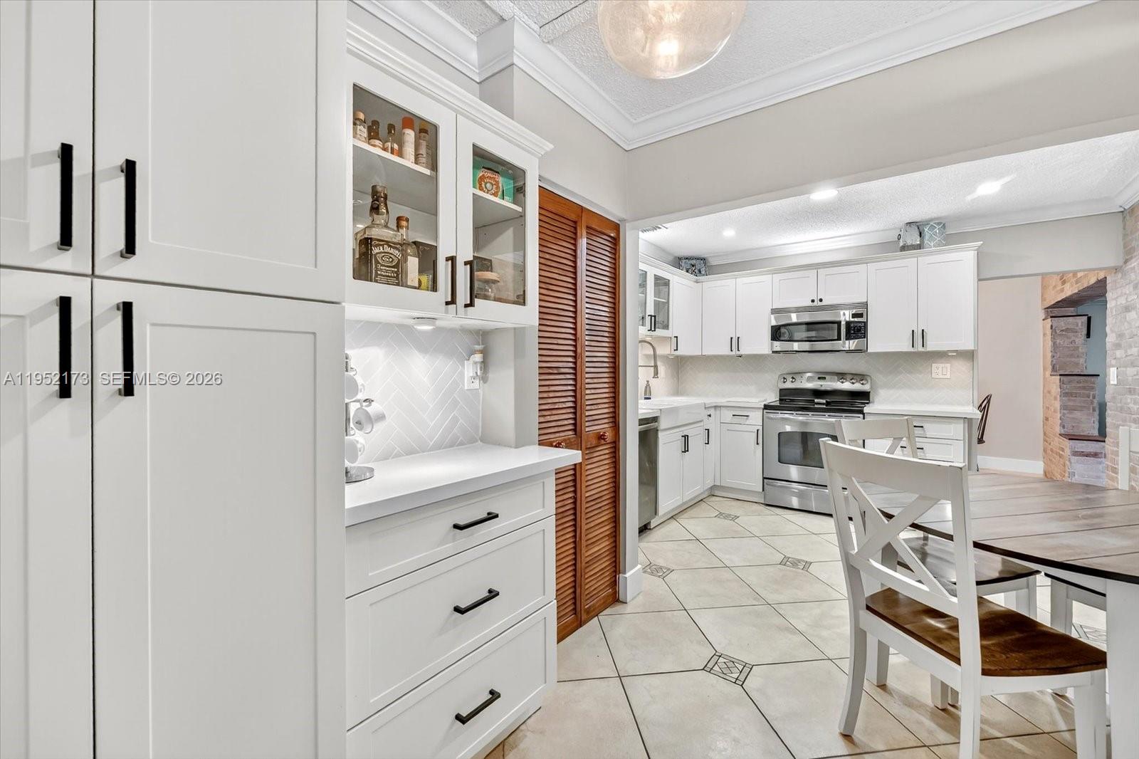 1300 West 77th Street Hialeah, FL 33014 - Photo 15 of 41 a kitchen with stainless steel appliances a refrigerator sink and cabinets