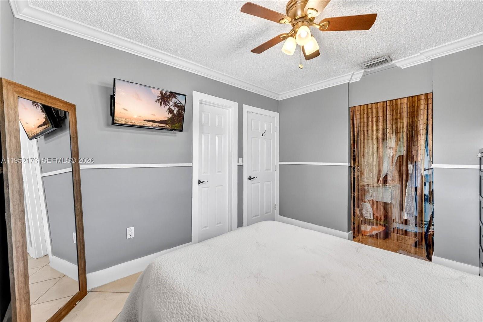 1300 West 77th Street Hialeah, FL 33014 - Photo 20 of 41 a bedroom with a bed and a chandelier