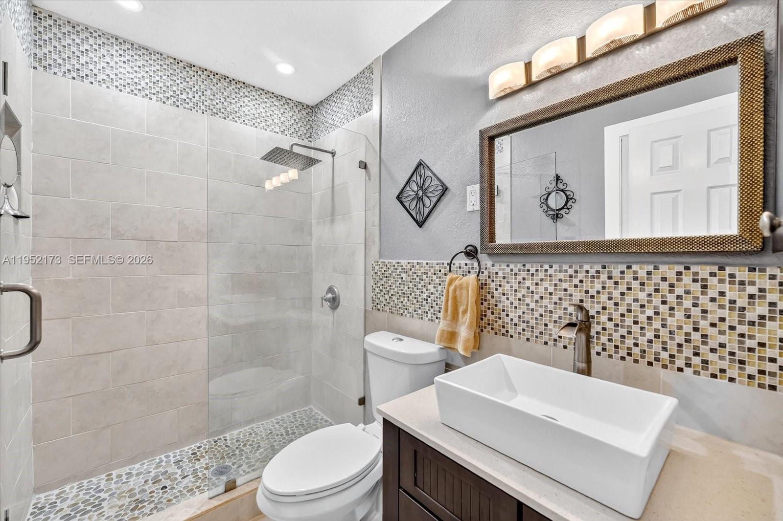 1300 West 77th Street Hialeah, FL 33014 - Photo 21 of 41 a bathroom with a toilet a sink and a shower