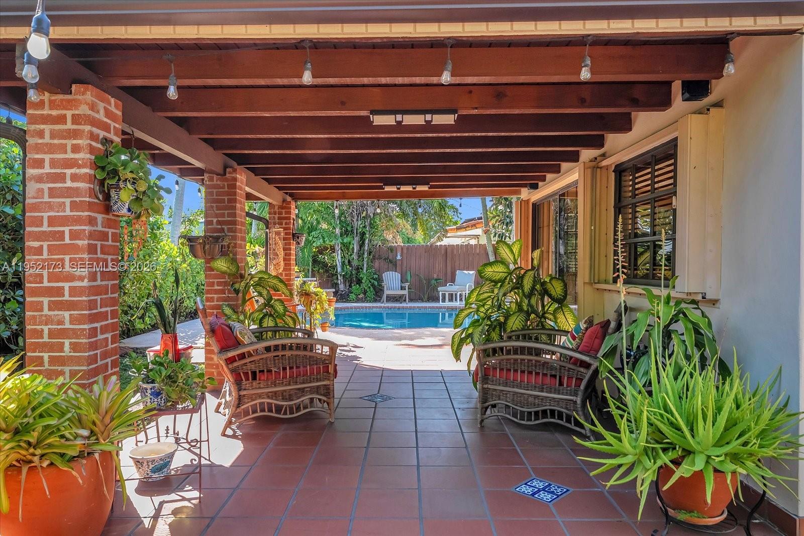 1300 West 77th Street Hialeah, FL 33014 - Photo 30 of 41 a view of a porch with furniture and a potted plant
