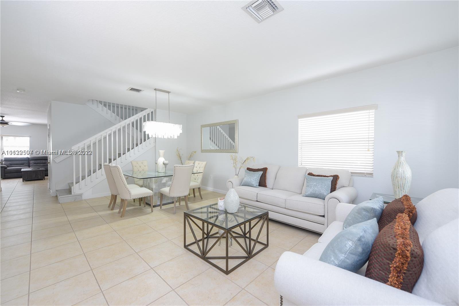 24221 Southwest 112th Court Homestead, FL 33032 - Photo 11 of 25 a living room with furniture and a large window