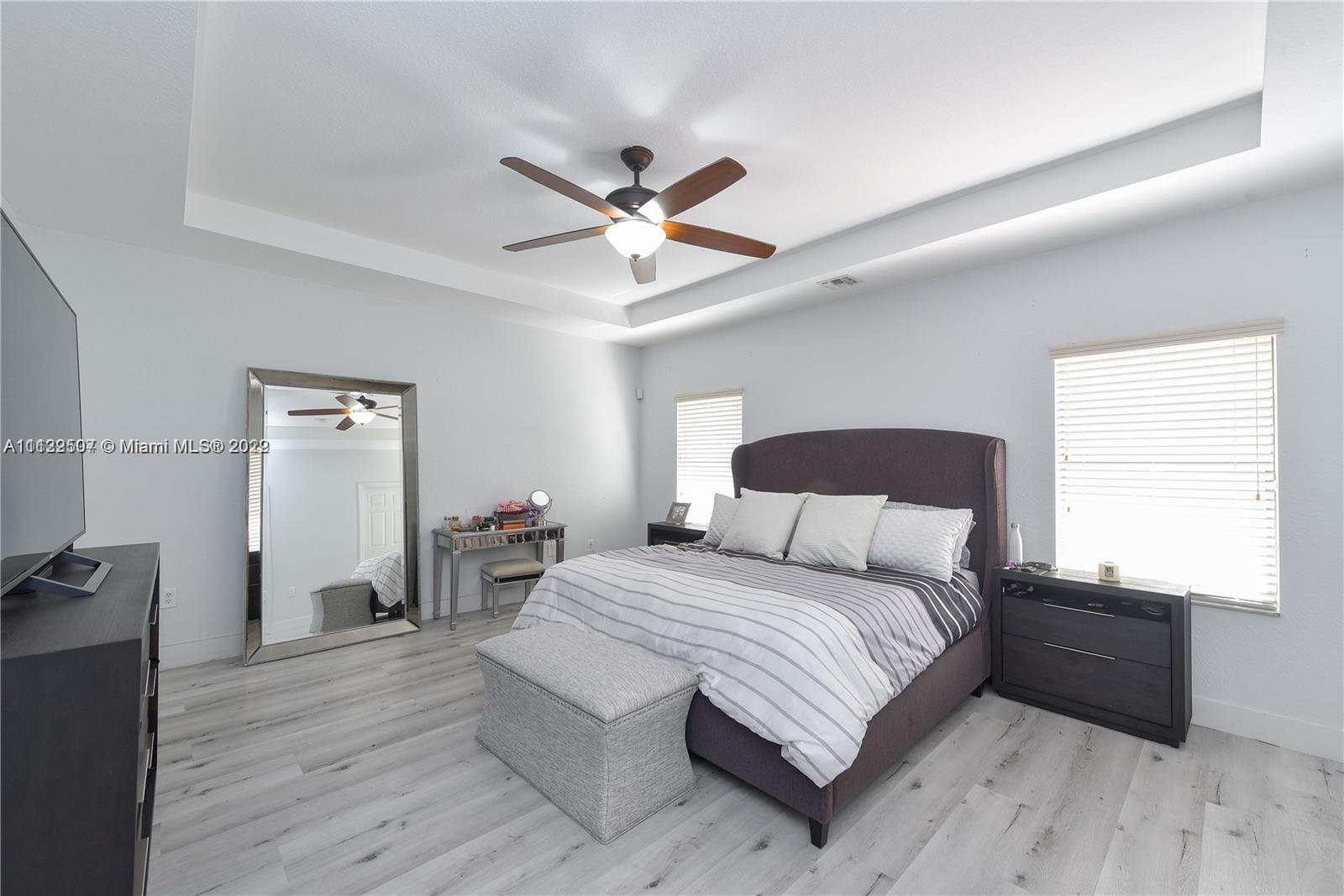 24221 Southwest 112th Court Homestead, FL 33032 - Photo 15 of 25 a bedroom with a bed and wooden floor