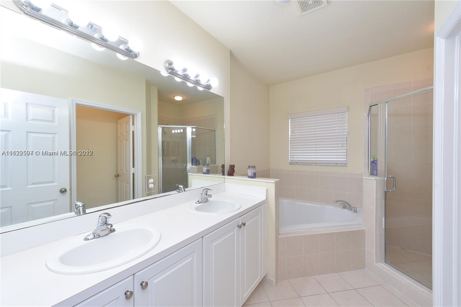 24221 Southwest 112th Court Homestead, FL 33032 - Photo 16 of 25 a bathroom with a tub double sink and mirror