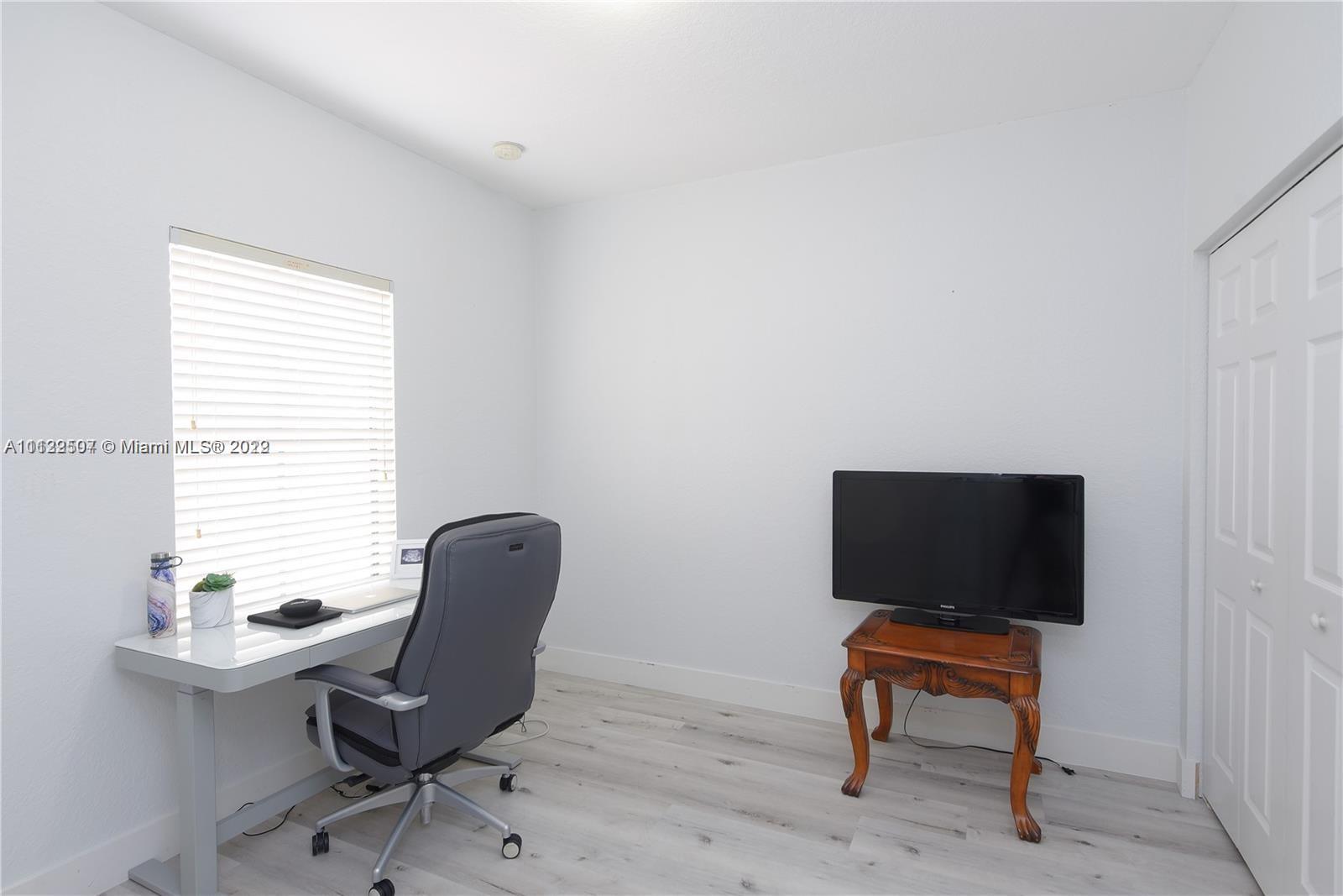 24221 Southwest 112th Court Homestead, FL 33032 - Photo 19 of 25 a view of a workspace with furniture and a window