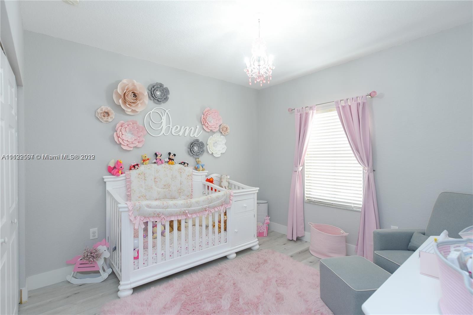 24221 Southwest 112th Court Homestead, FL 33032 - Photo 20 of 25 a bedroom with baby bed baby crib and a window