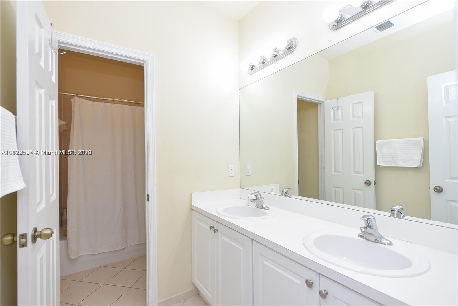 24221 Southwest 112th Court Homestead, FL 33032 - Photo 21 of 25 a bathroom with a sink and a mirror