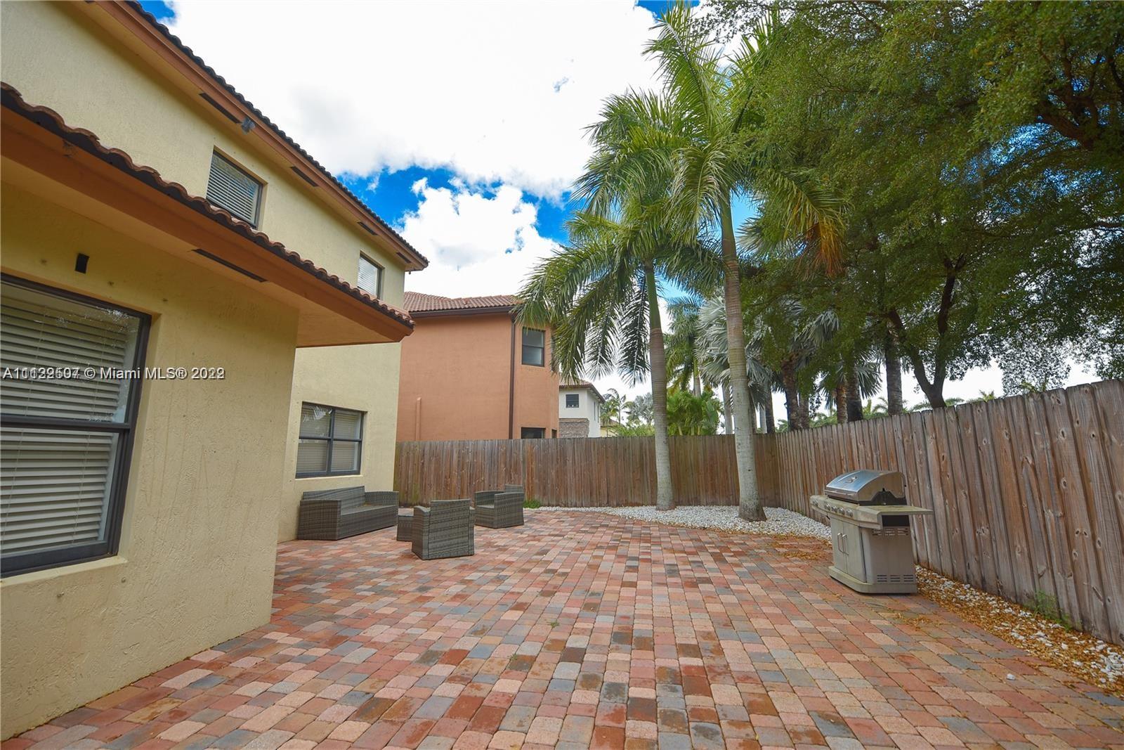 24221 Southwest 112th Court Homestead, FL 33032 - Photo 23 of 25 a backyard of a house with fountain table and chairs