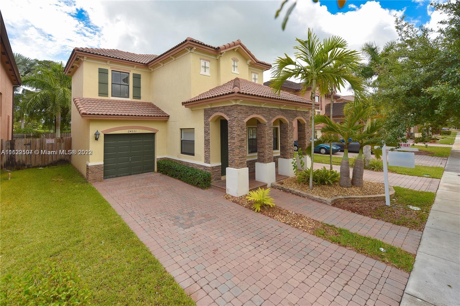 24221 Southwest 112th Court Homestead, FL 33032 - Photo 25 of 25 a front view of a house with a garden and mountain view
