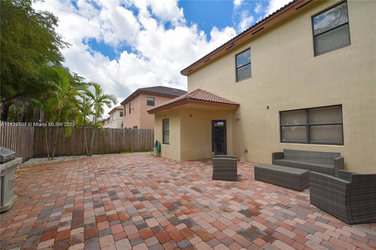 24221 Southwest 112th Court Homestead, FL 33032 - Photo 4 of 25 a front view of a house with a yard and wooden fence