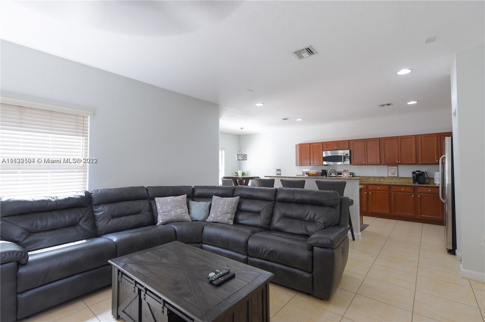24221 Southwest 112th Court Homestead, FL 33032 - Photo 9 of 25 a living room with furniture and kitchen view