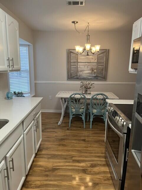 402 Juniper Street Destin, FL 32541 - Photo 6 of 20 a kitchen with stainless steel appliances granite countertop a kitchen island hardwood floor and a sink