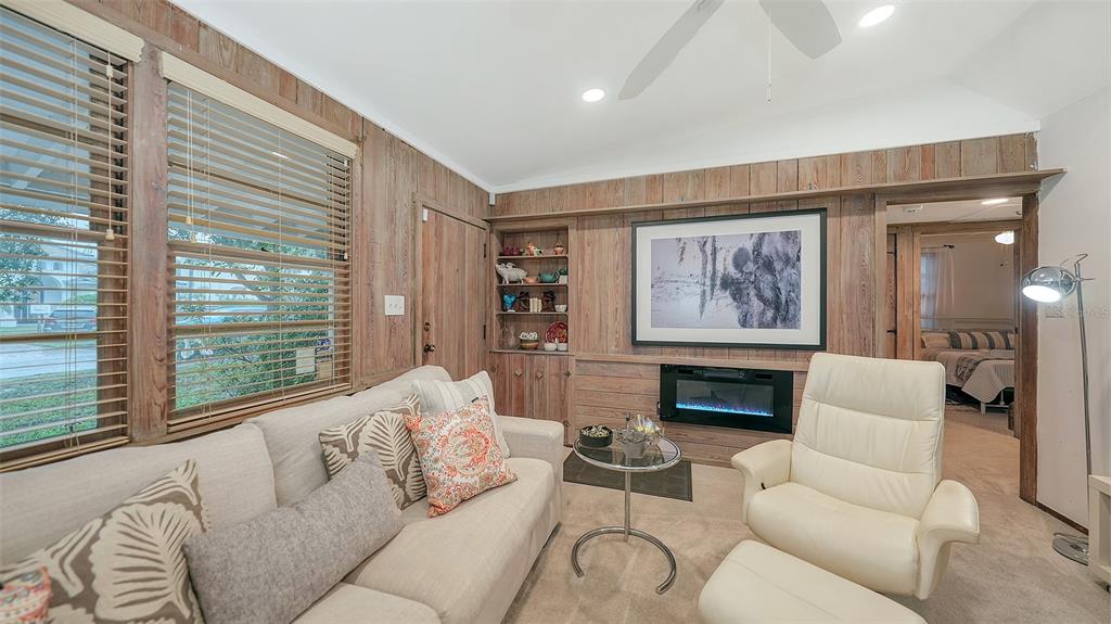 1702 Hillview Street Sarasota, FL 34239 - Photo 17 of 67 a living room with furniture large window and a fireplace