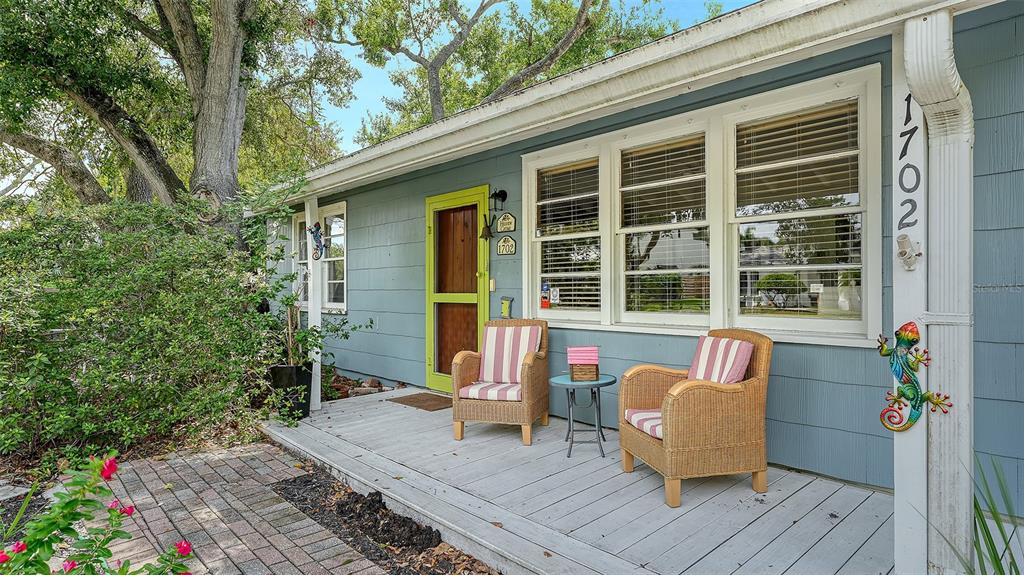 1702 Hillview Street Sarasota, FL 34239 - Photo 2 of 67 a roof deck with table and chairs and potted plants