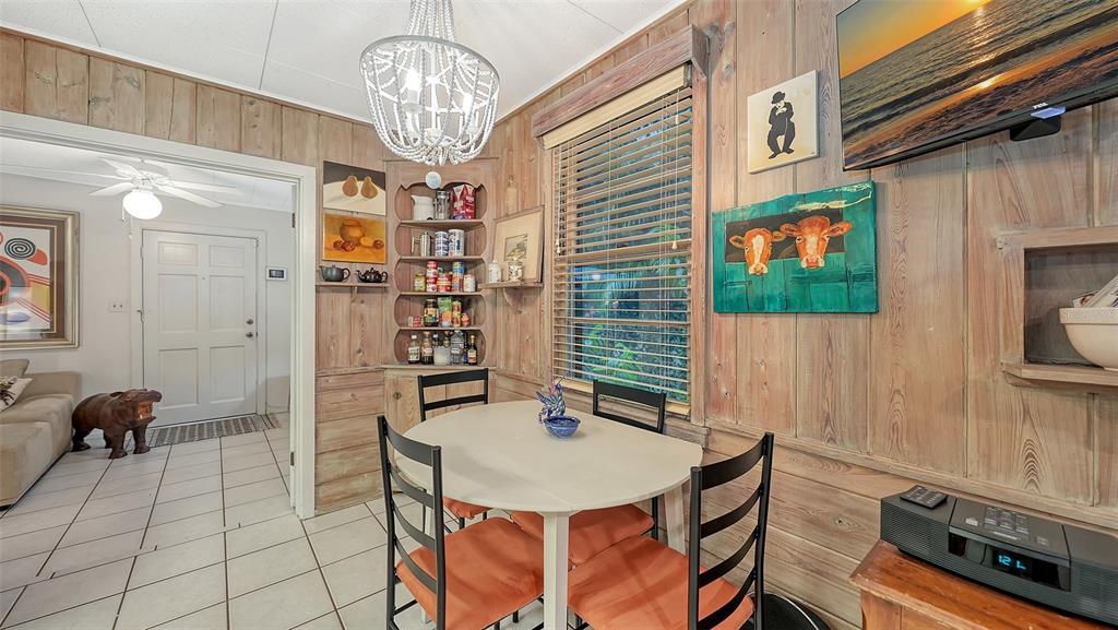1702 Hillview Street Sarasota, FL 34239 - Photo 21 of 67 a view of a dining room with furniture and chandelier