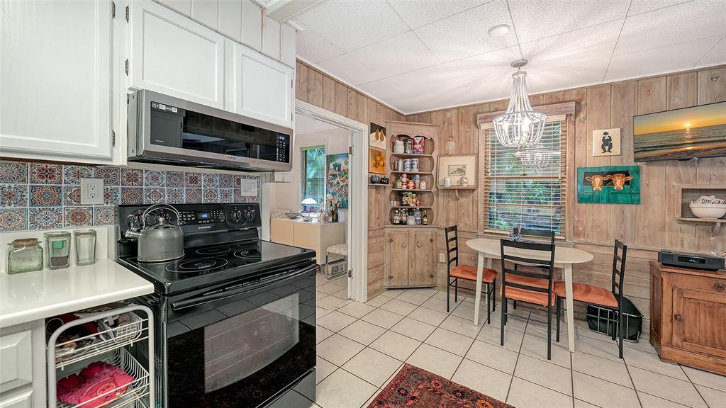 1702 Hillview Street Sarasota, FL 34239 - Photo 26 of 67 a kitchen with stainless steel appliances a stove a microwave and a refrigerator