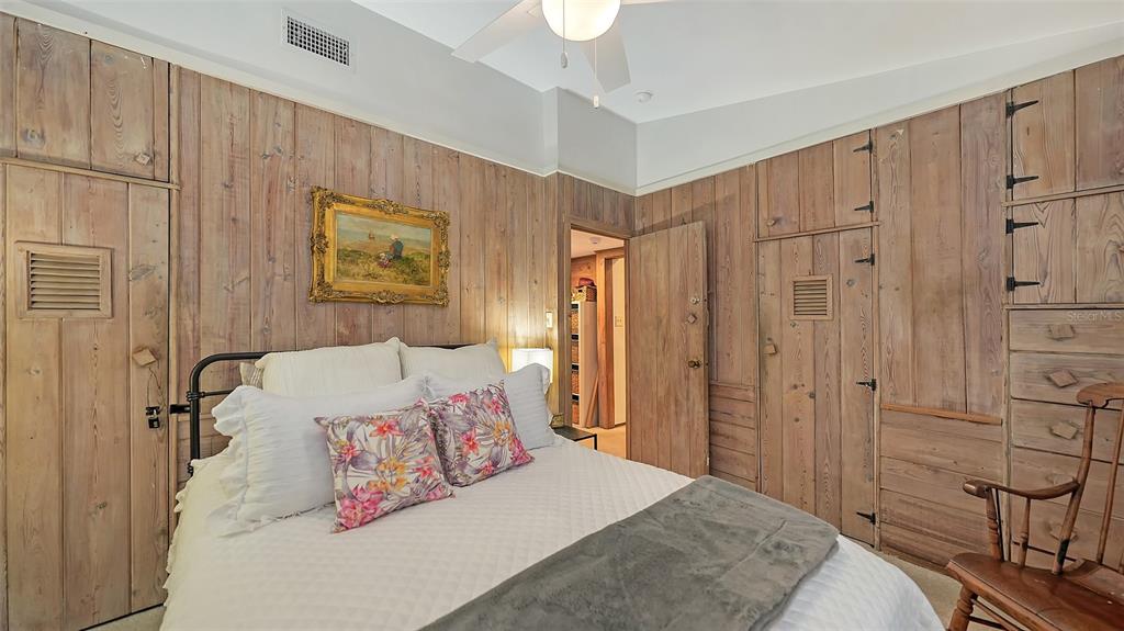 1702 Hillview Street Sarasota, FL 34239 - Photo 29 of 67 a bedroom with a bed and a cabinets
