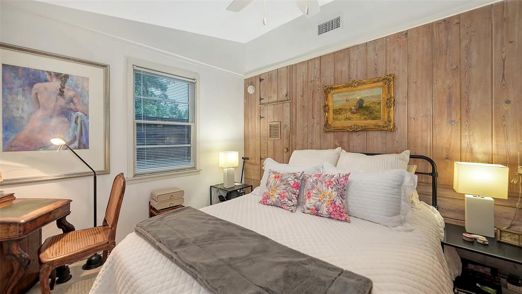 1702 Hillview Street Sarasota, FL 34239 - Photo 31 of 67 a bedroom with a bed and wooden floor