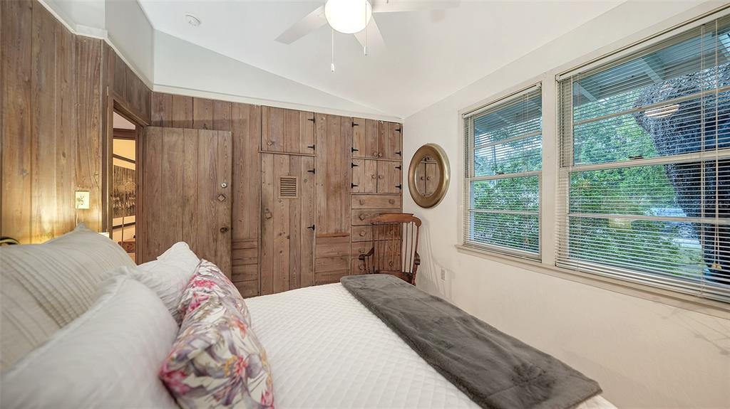 1702 Hillview Street Sarasota, FL 34239 - Photo 32 of 67 a bedroom with a large bed and a chandelier