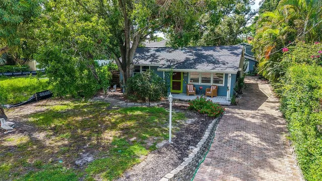 a view of a house with a yard and tree s