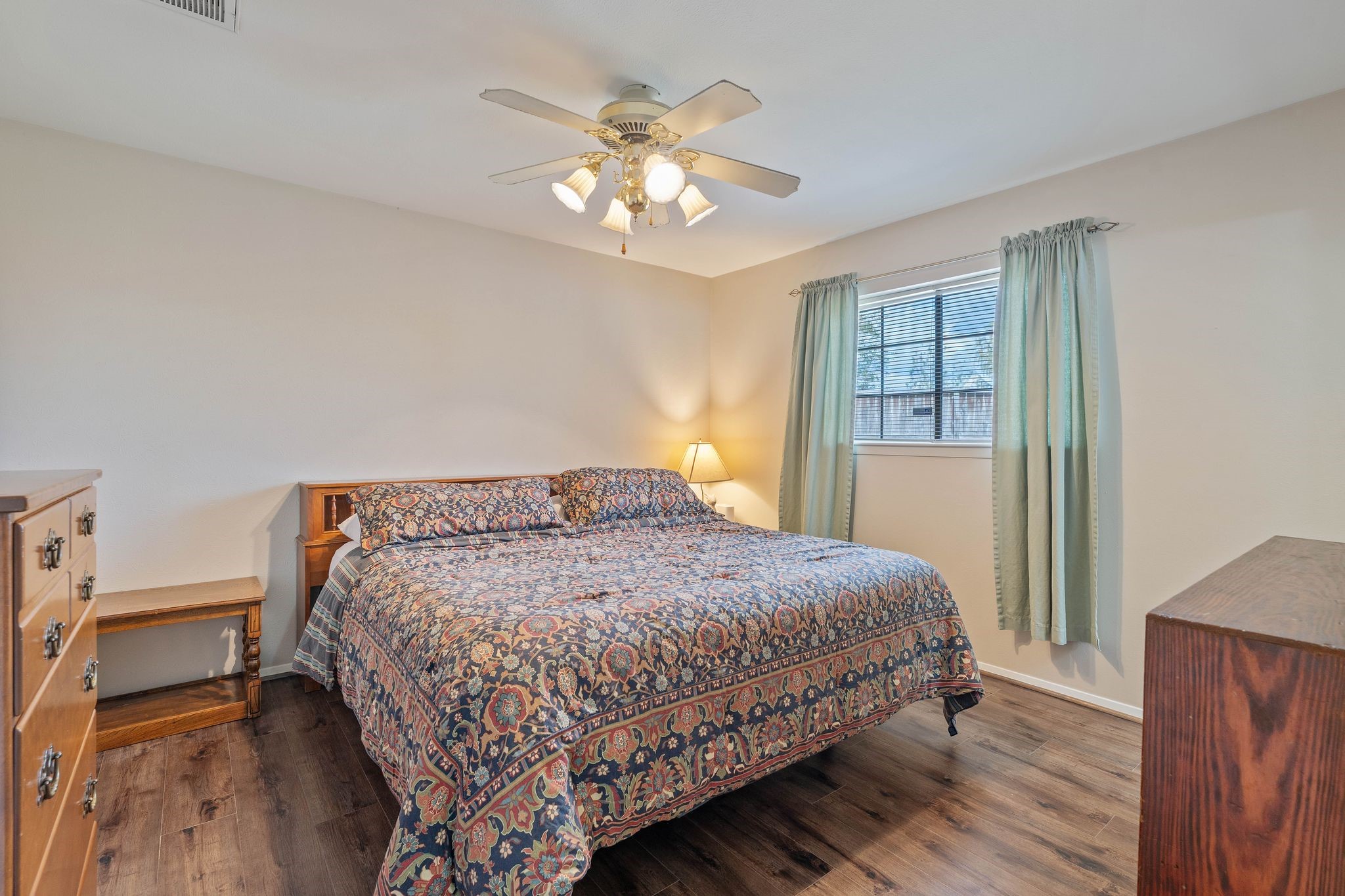 23019 Rothwood Road Spring, TX 77389 - Photo 16 of 30 a bedroom with a bed and a chandelier