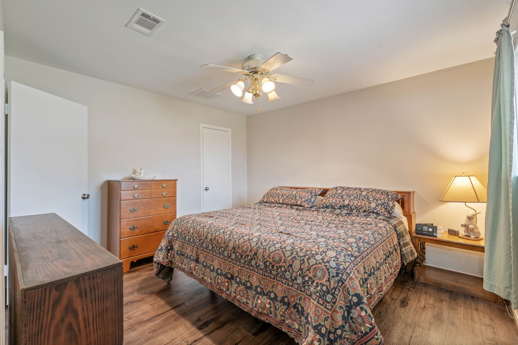 23019 Rothwood Road Spring, TX 77389 - Photo 17 of 30 a bedroom with a bed and a chandelier