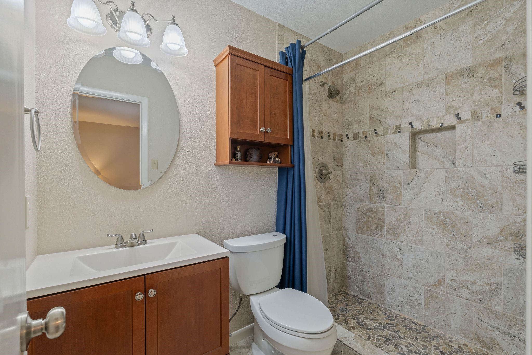 23019 Rothwood Road Spring, TX 77389 - Photo 18 of 30 a bathroom with a toilet a sink a shower and mirror