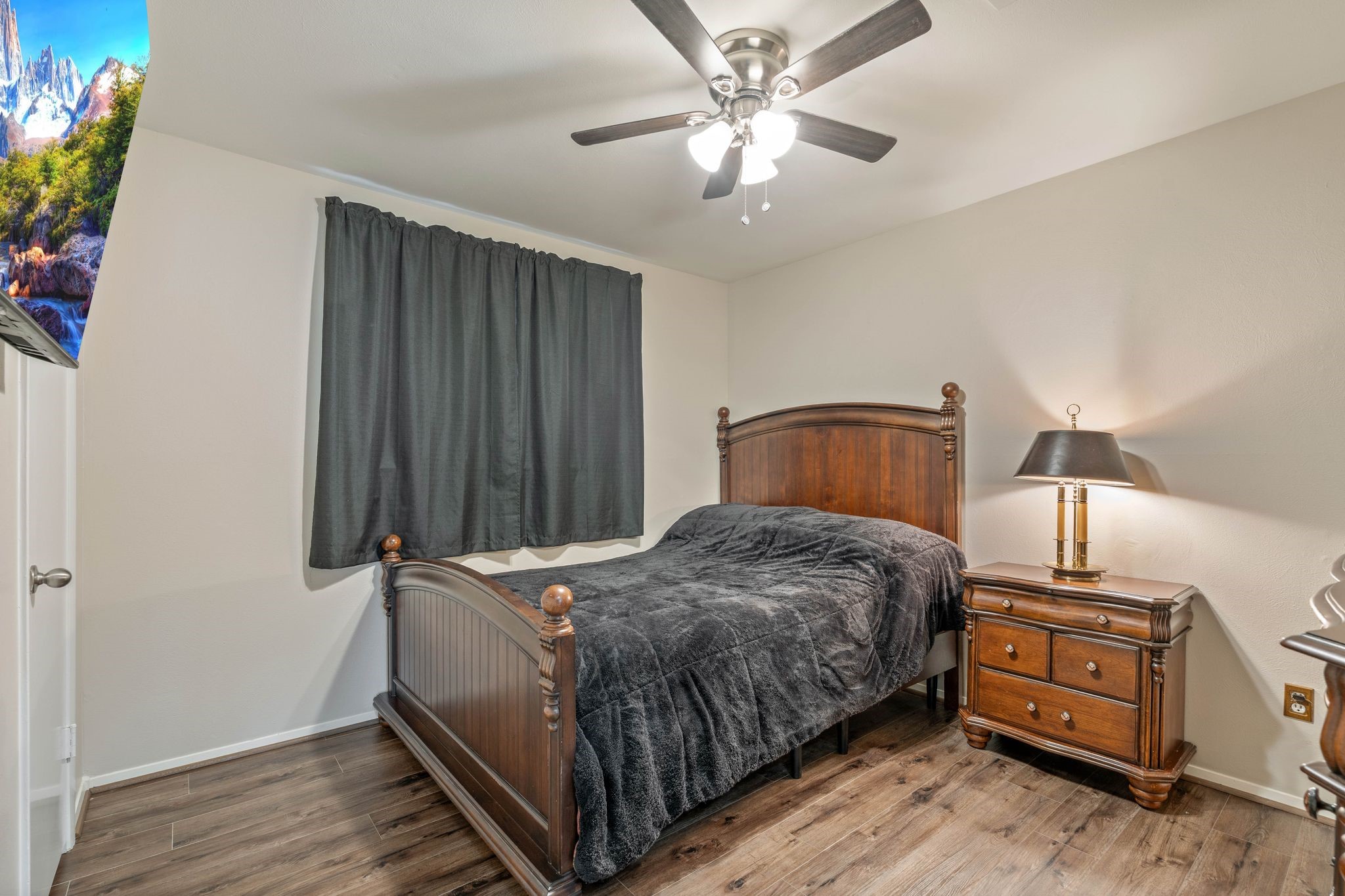 23019 Rothwood Road Spring, TX 77389 - Photo 19 of 30 a bedroom with a bed and a chandelier