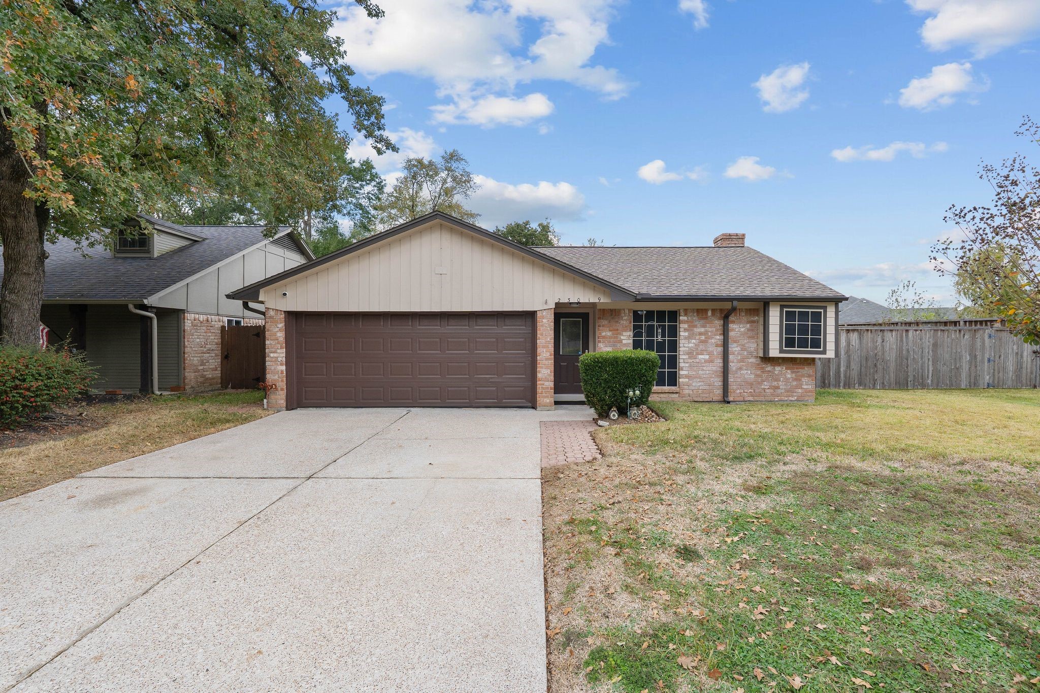 23019 Rothwood Road Spring, TX 77389 - Photo 2 of 30 a front view of a house with a garden