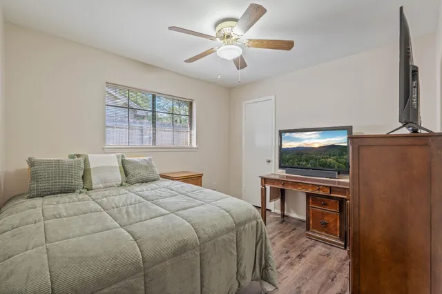 a bedroom with a bed and a flat screen tv