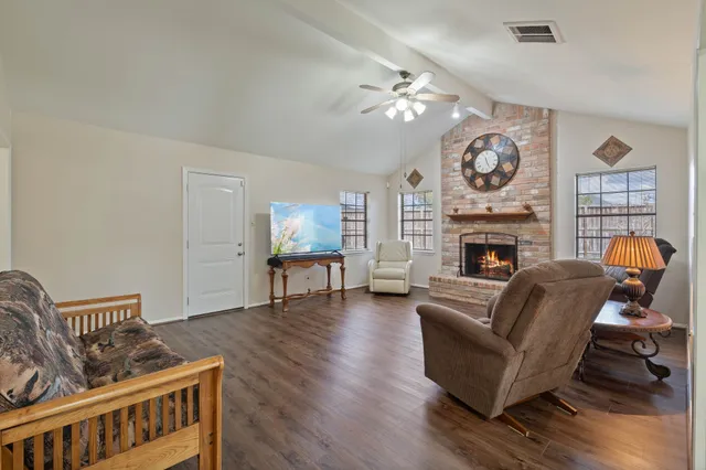 a living room with furniture and a fireplace