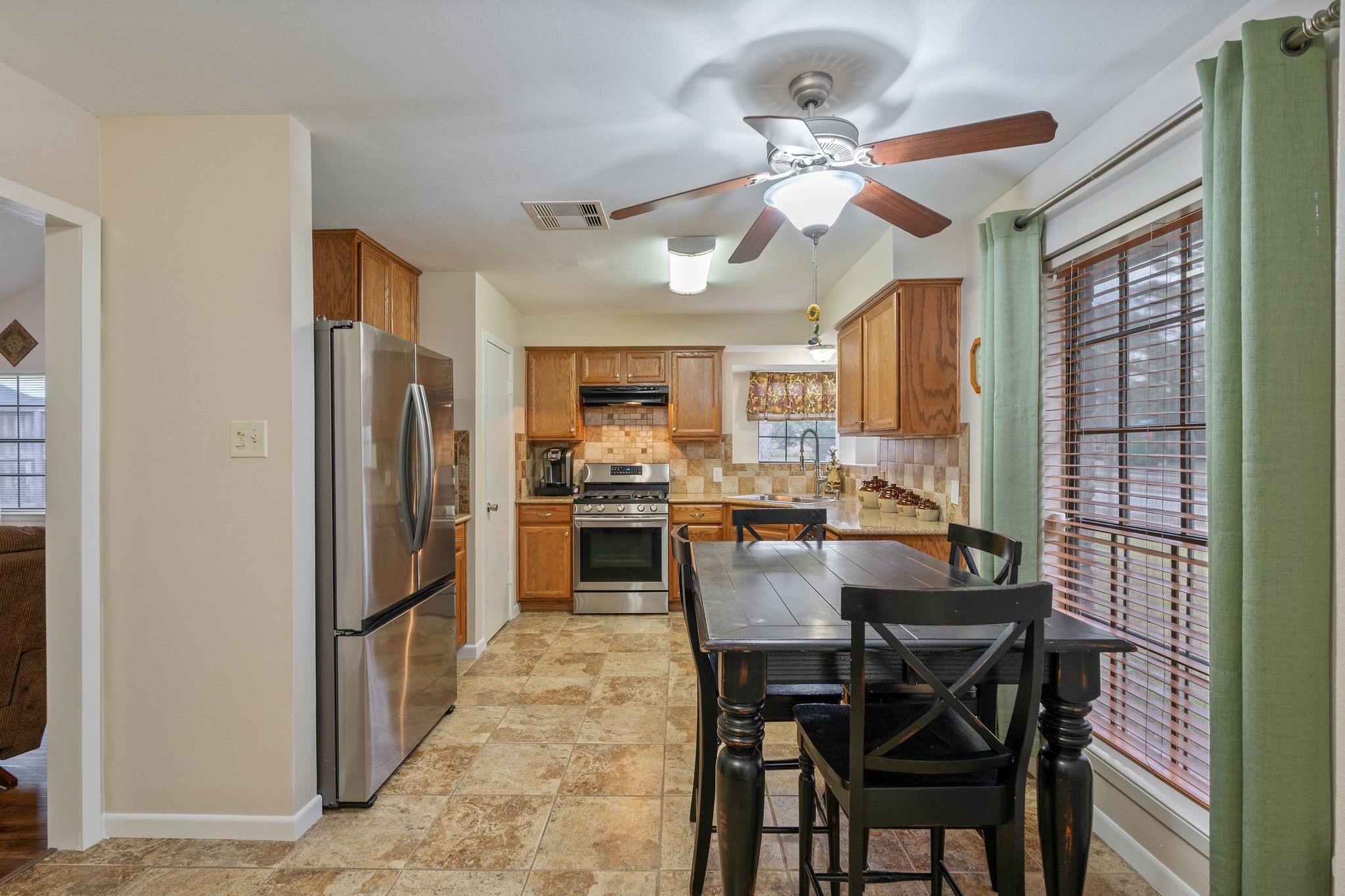23019 Rothwood Road Spring, TX 77389 - Photo 10 of 30 a view of a dining room with furniture and a chandelier