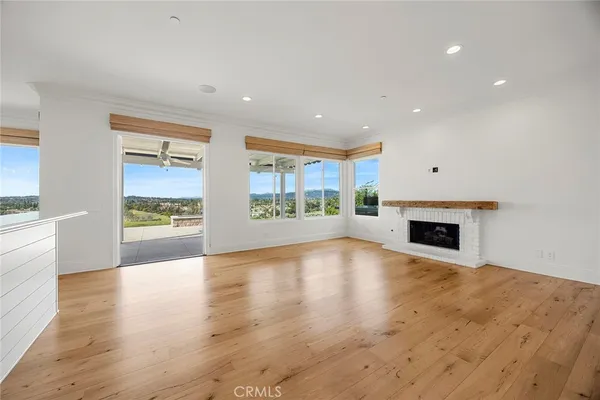 a spacious bedroom with a bed and a flat screen tv