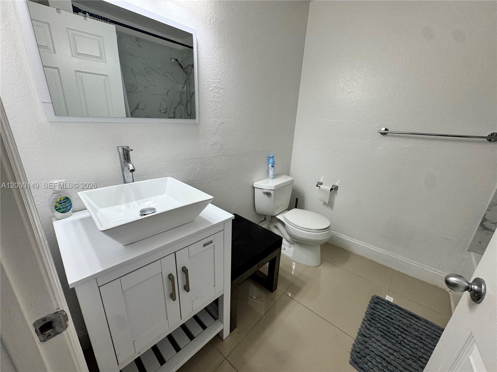 8415 Harding Avenue, Unit 9 Miami Beach, FL 33141 - Photo 11 of 14 a bathroom with a sink toilet and mirror