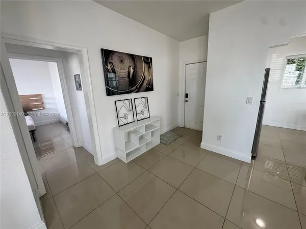 a view of a livingroom with wooden floor and a flat screen tv
